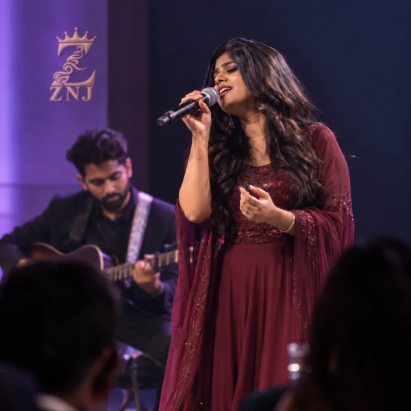 Singer and guitarist performing on a stage with ZNJ branding.