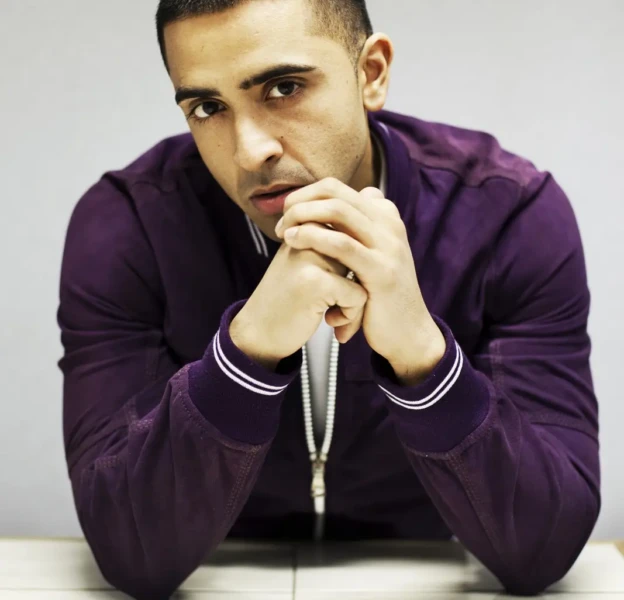 Jay Sean in a purple jacket, seated for a portrait